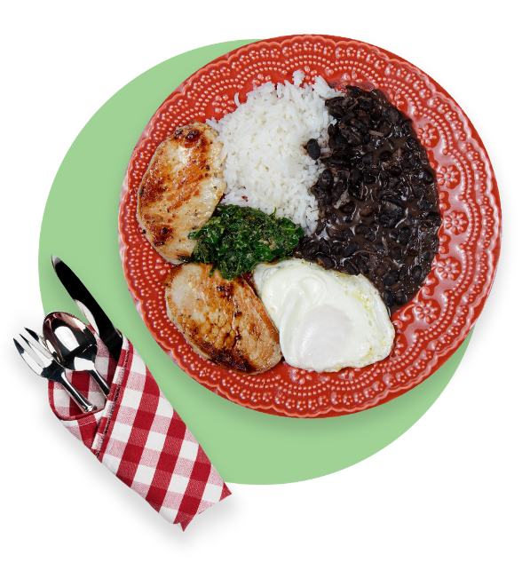 Plate with rice, chicken, beans, spinach, and mashed potatoes with cutlery in a napkin next to plate
