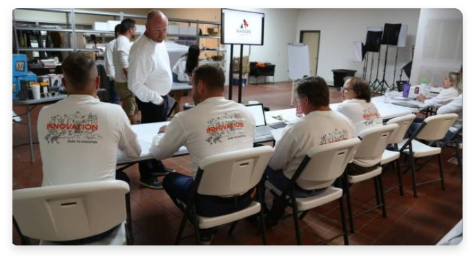 net pay employees sitting at table during handler's summit