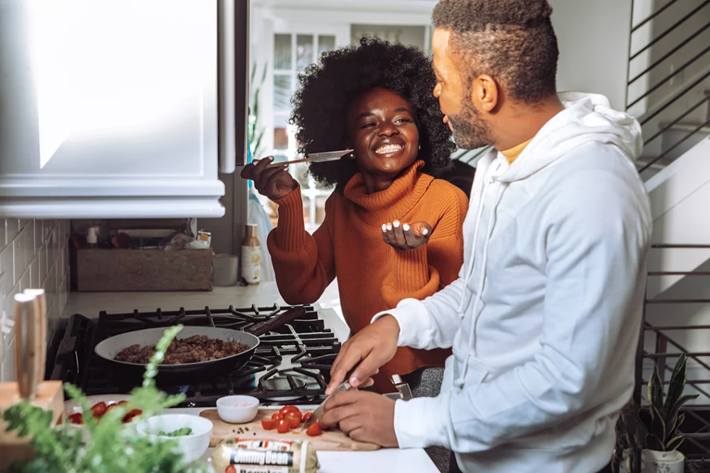 Couple cooking dinner together in their kitchen