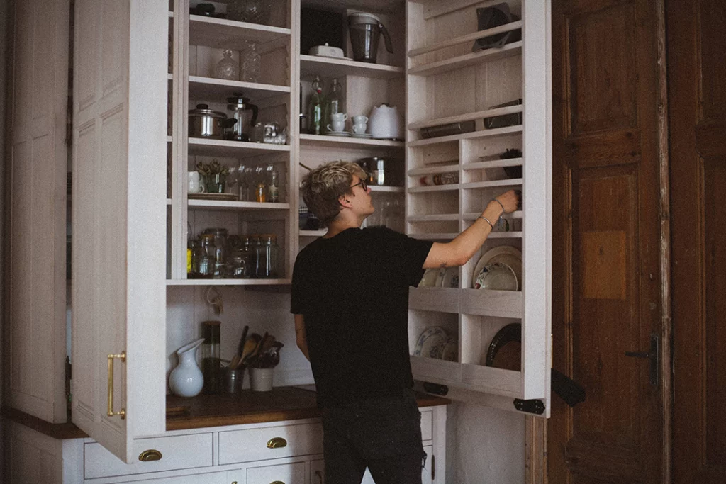 Person looking into nicely organized kitchen cabinets