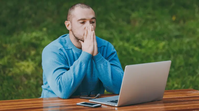 man looking frustrated at computer