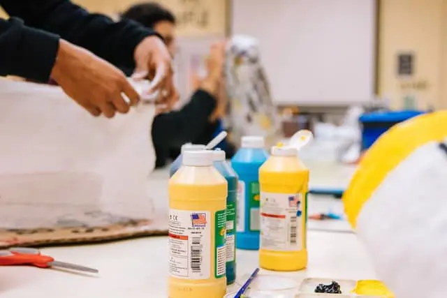 Paint bottles and brushes on a table