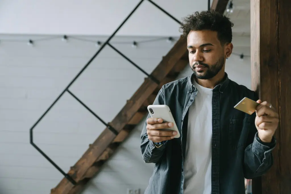 Image of man holding credit card