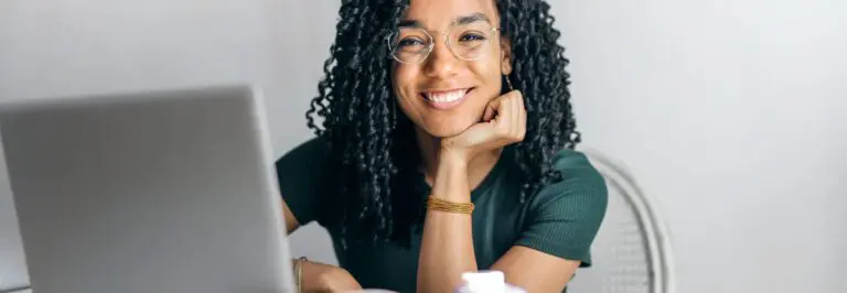 woman with chin resting on wrist, smiling