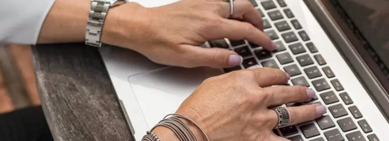 woman typing on laptop keyboard