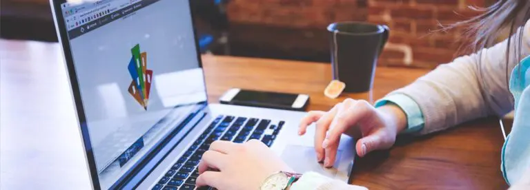 woman typing on laptop in a cafe