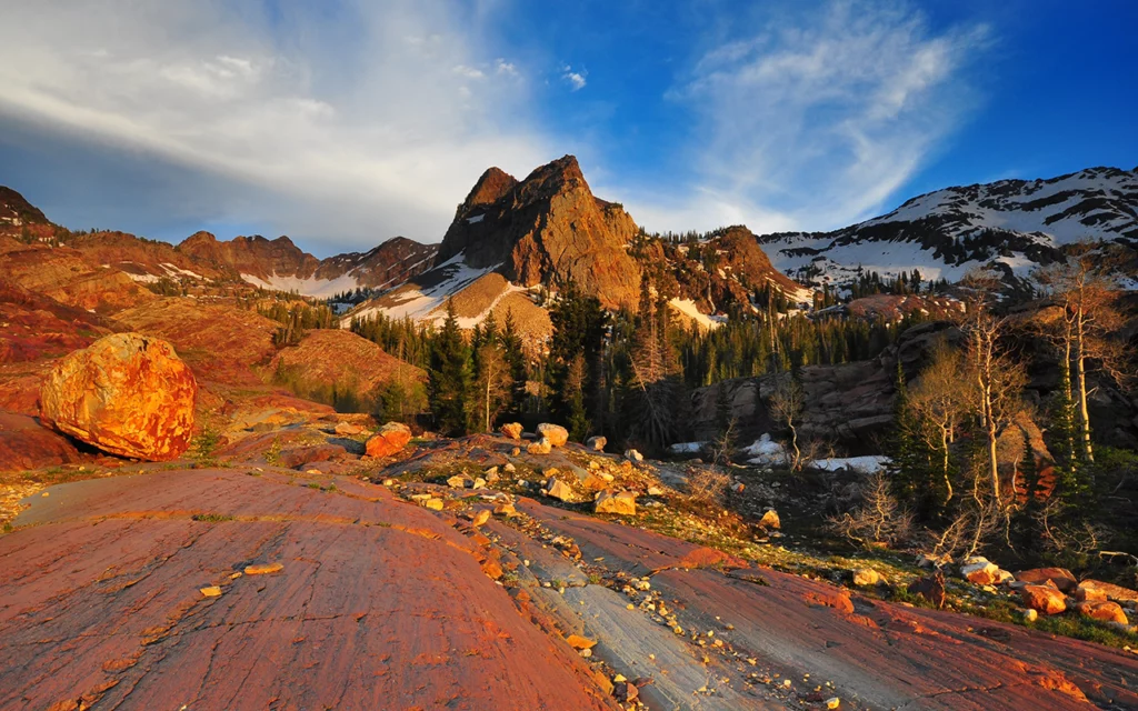 Big Cottonwood Canyon in Utah. It’s not too far from Salt Lake City. Flat rock gives way to hiking trails through trees, and up to a mountain.