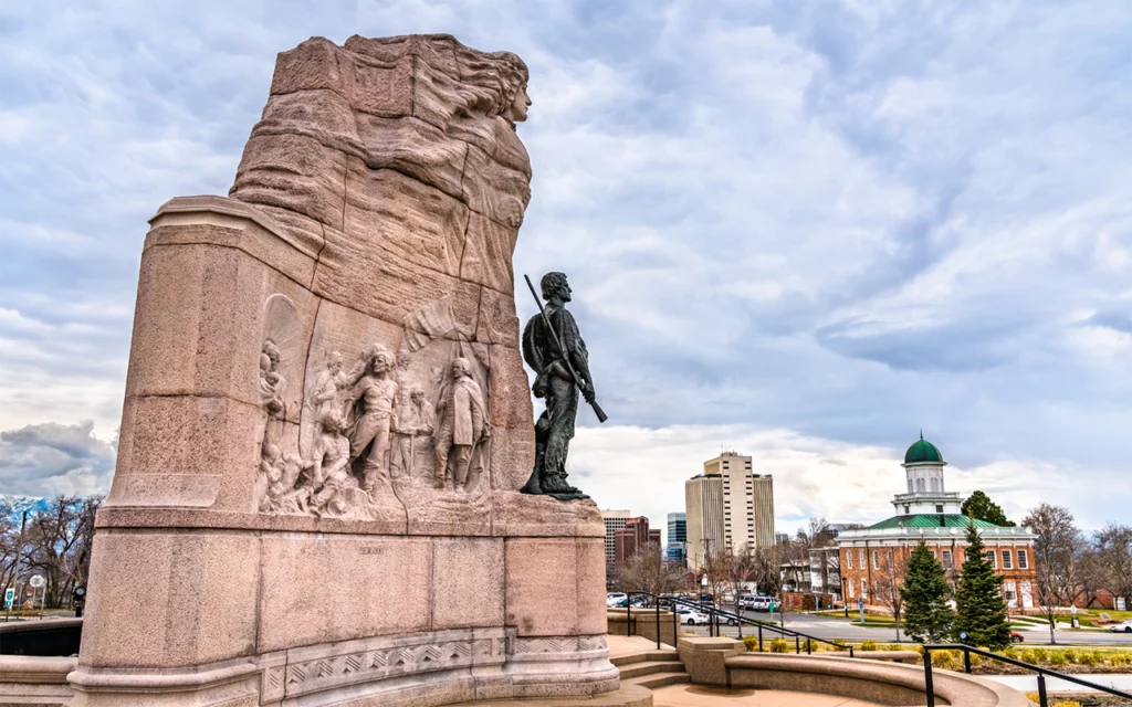 Side view of the Mormon Battalion Monument. Salt Lake City can be seen in the background.