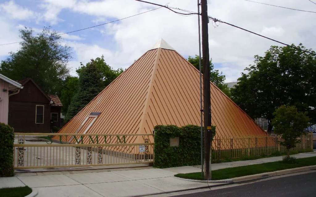 Unique pyramid-shaped building in Salt Lake City. It has a fence around it that says “Summum”. This is the Summum Pyramid.