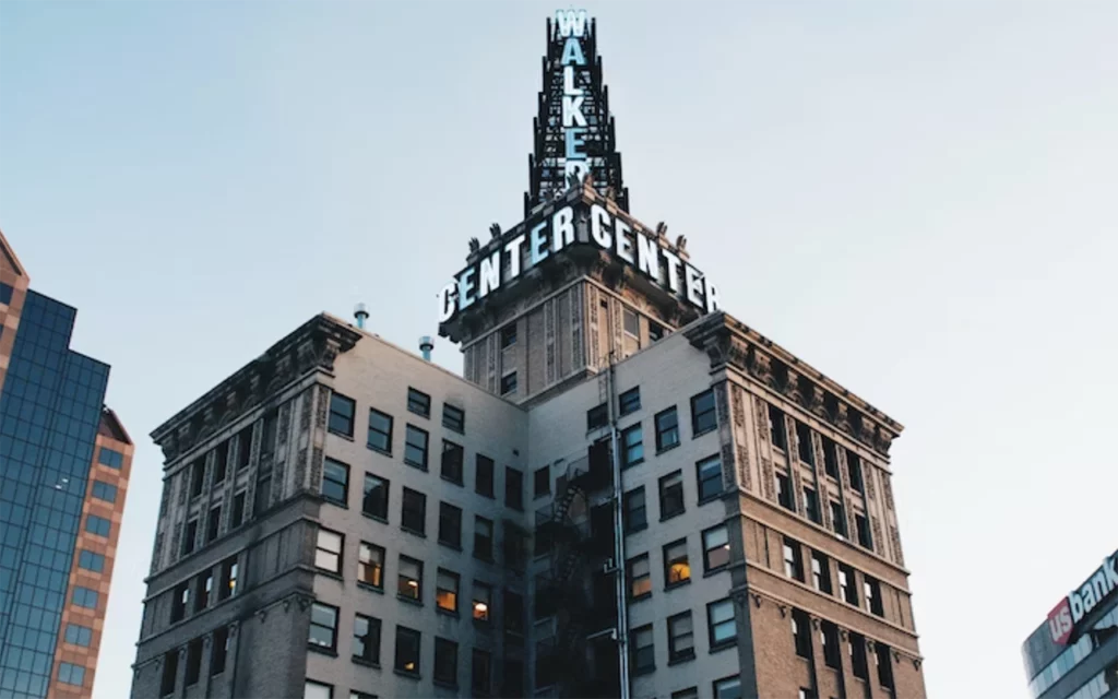 At the top of this tall building in Salt Lake City are the words “Walker Center”. The building appears to be filled with office space. There is a fire staircase on the side of the building