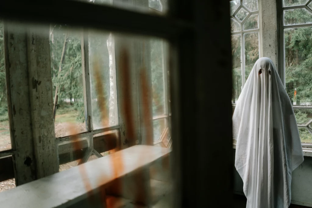 Image shows a figure clad in a white sheet