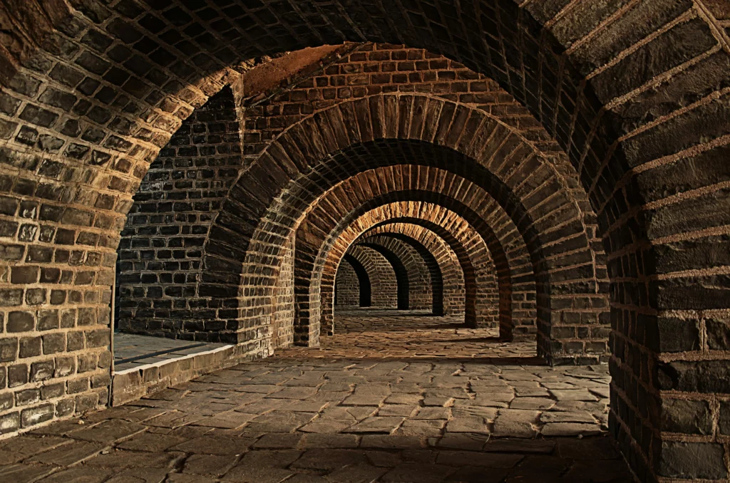 Image shows brick tunnel with series of archways